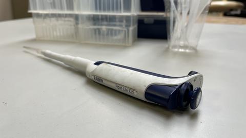 Pipette pen shown with pipette tip boxes and droppers