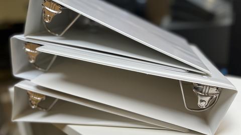 A stack of white binders