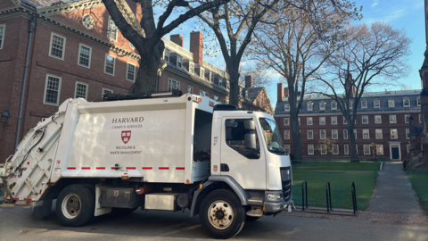 A recycling truck in front of an academic building