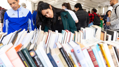 A woman perusing books at a reuse event