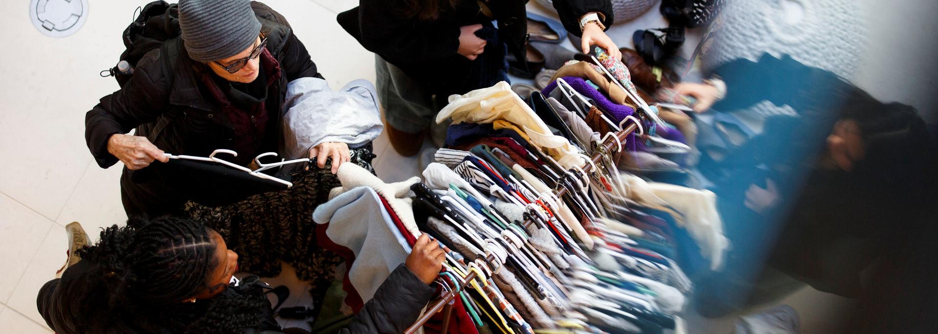 People browsing clothes at a Freecycle