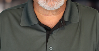 Headshot of a man in a gray polo
