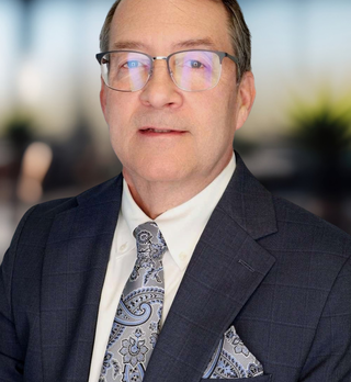Headshot of a man in business attire