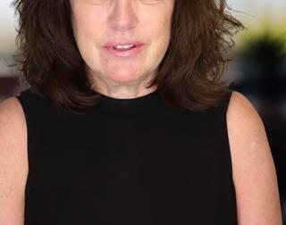 Headshot of a woman in a black shirt