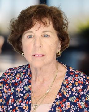 Headshot of a woman in a floral shirt