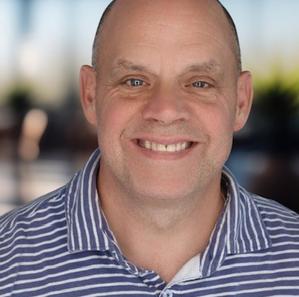 Headshot of a man in a polo