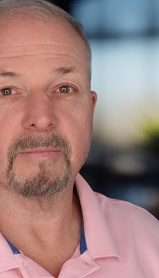 Headshot of a man in a polo