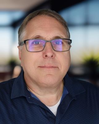 Headshot of a man in a polo