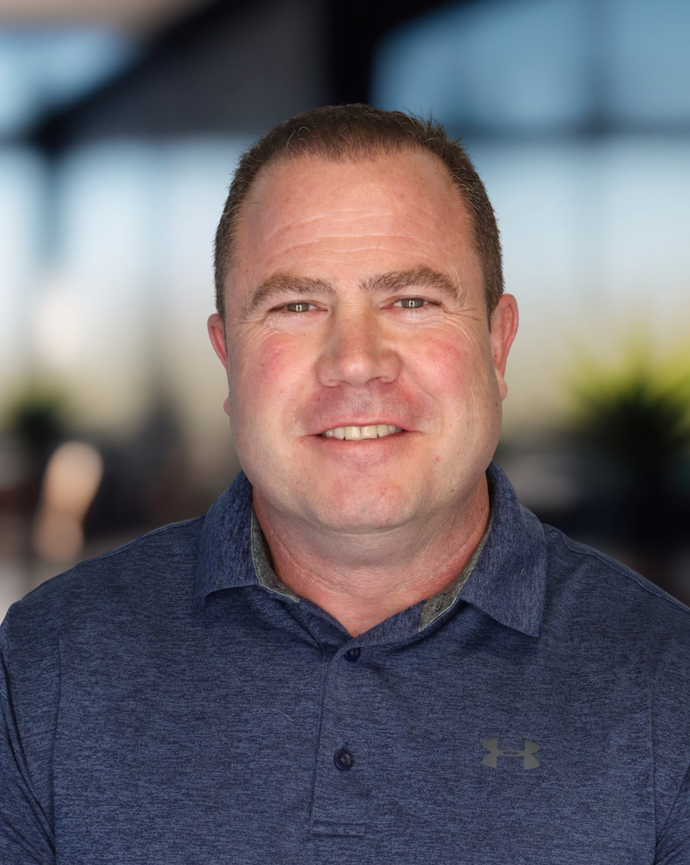 Headshot of a man in a blue polo