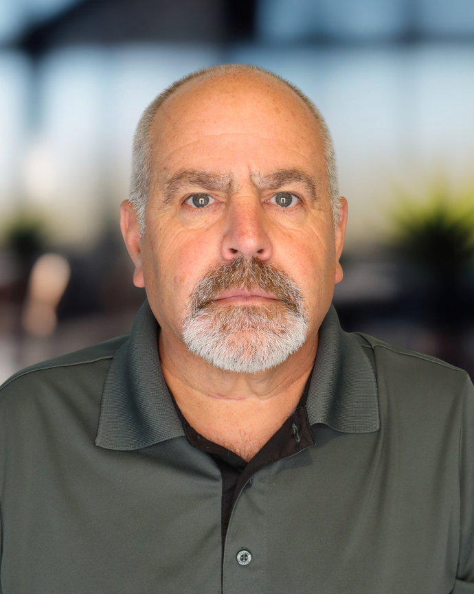 Headshot of a man in a gray polo