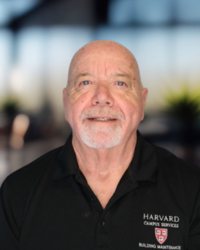 Headshot of a man in a dark polo shirt