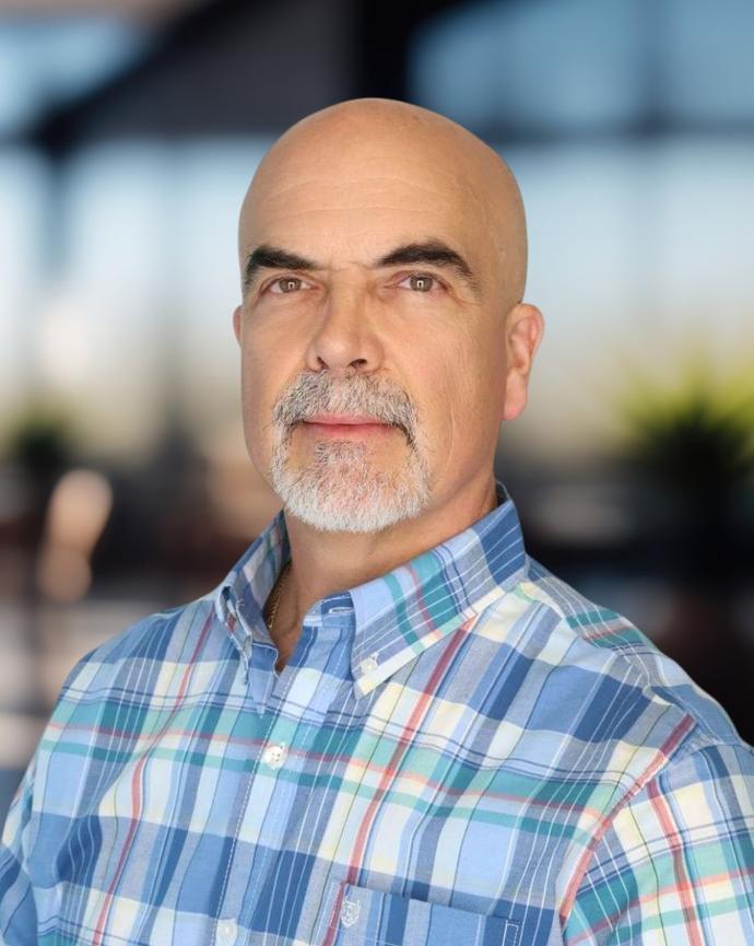 Headshot of a man in a plaid shirt