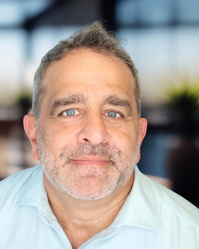 Headshot of a man in a blue polo