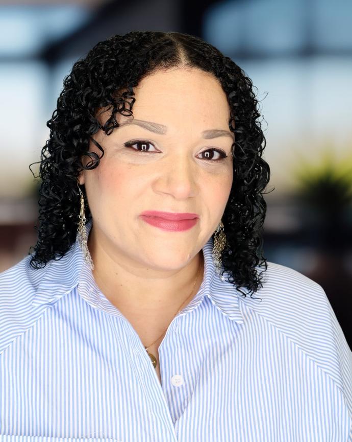 Headshot of a woman in a blue and white shirt
