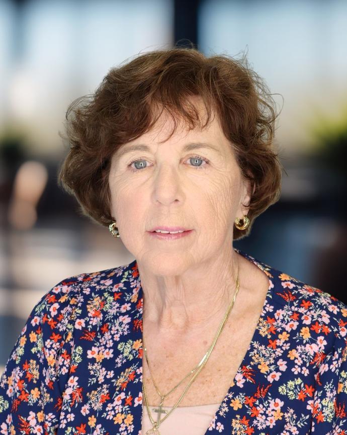 Headshot of a woman in a floral shirt