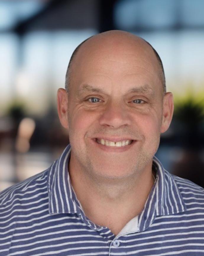 Headshot of a man in a polo