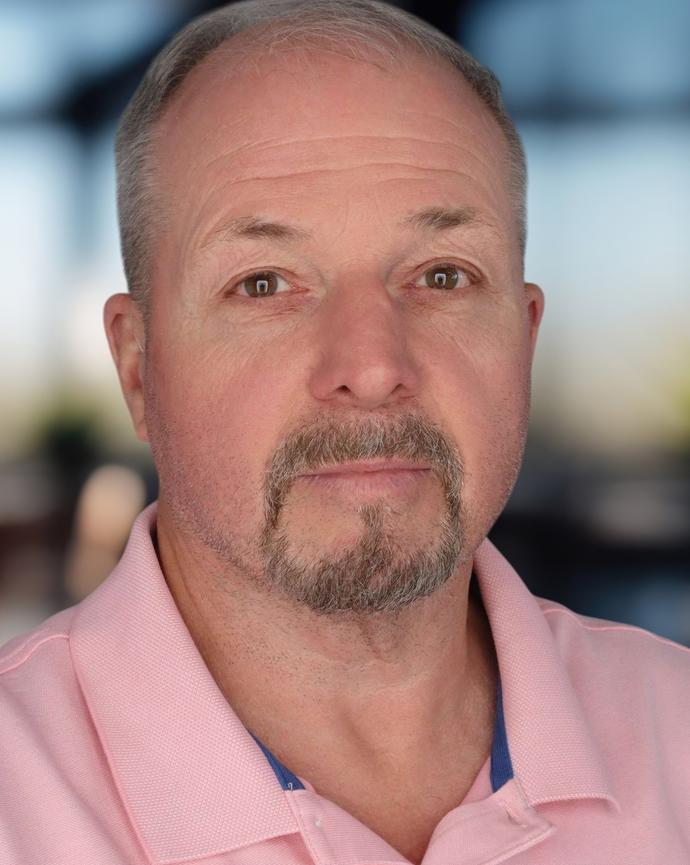 Headshot of a man in a polo