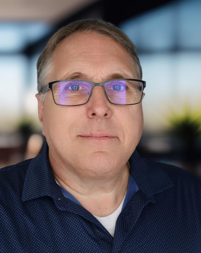 Headshot of a man in a polo