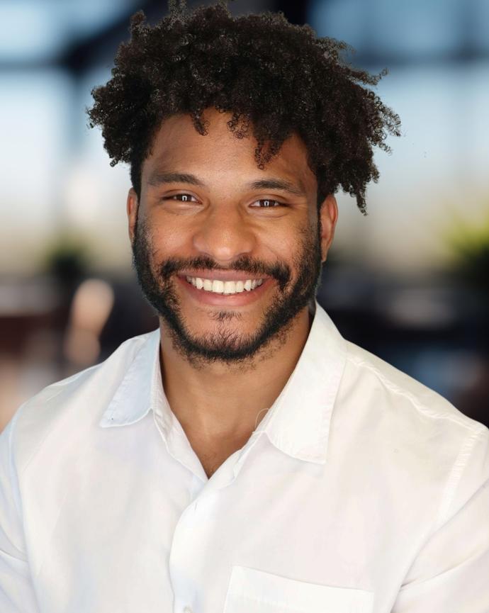 Headshot of a man in a white button-down
