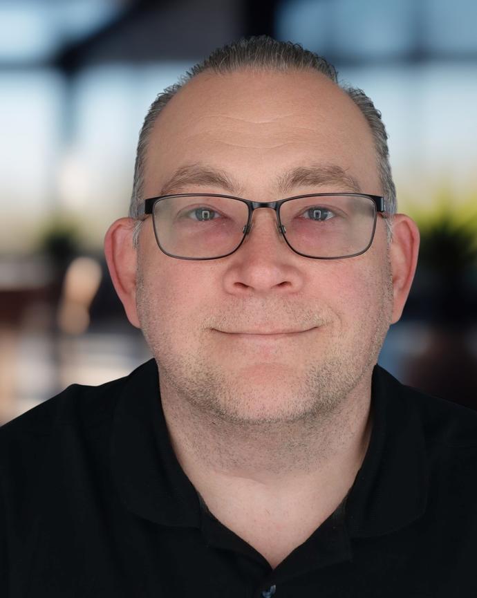 Headshot of a man in a polo